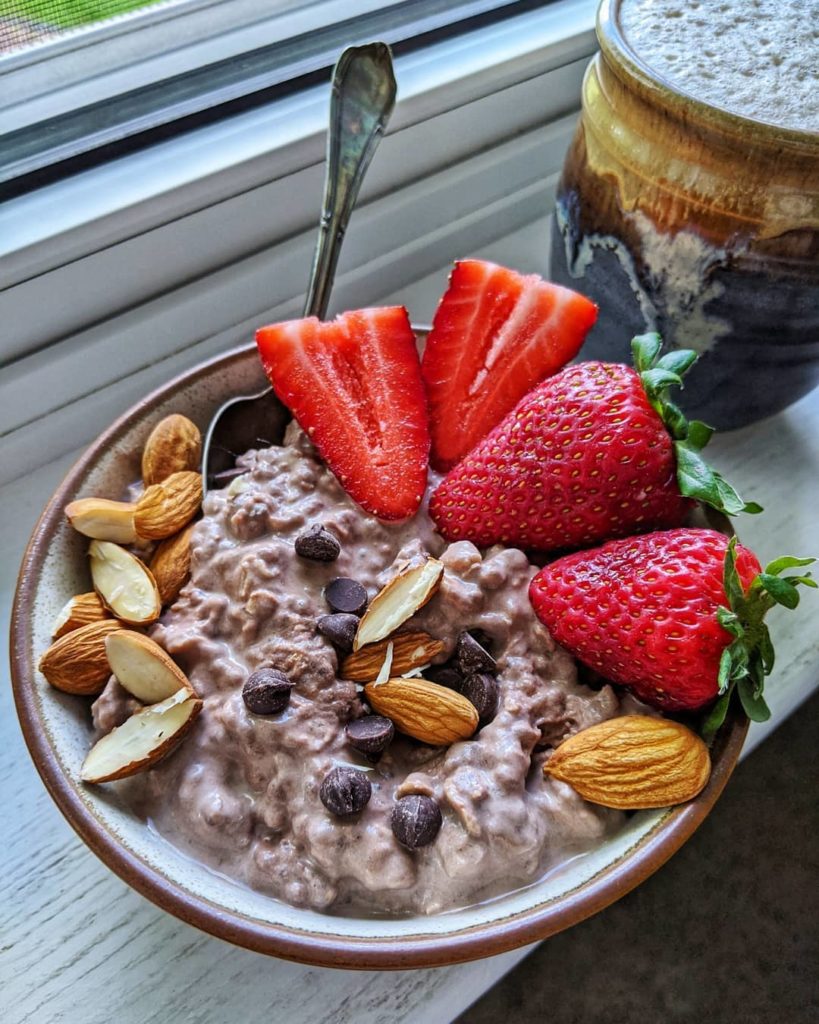 Overnight oats topped with strawberries, chocolate chips, and almonds