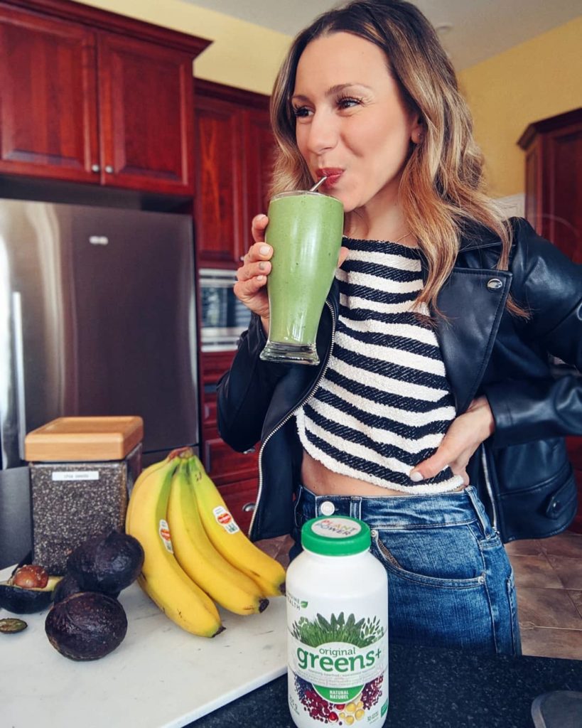 Natalie Pupo drinking a green smoothie in a kitchen