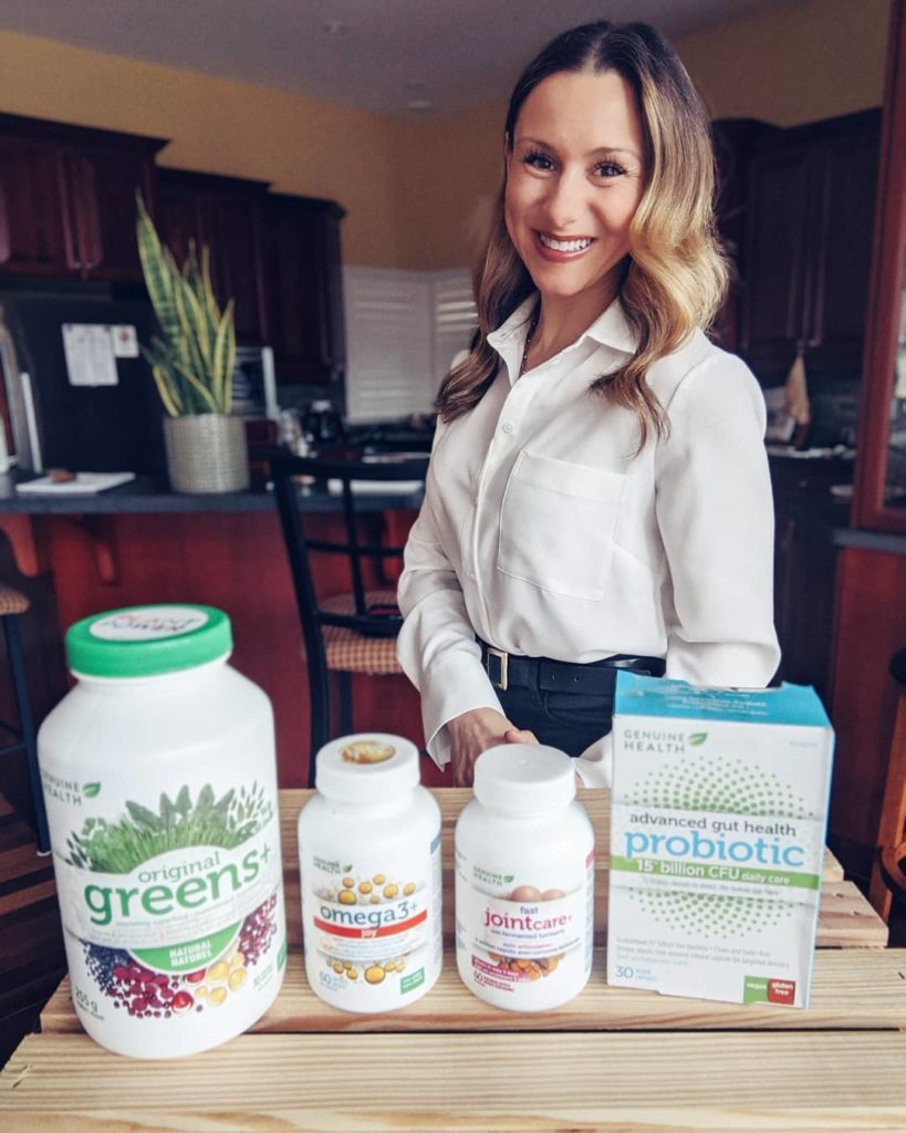 Natalie Pupo smiling and standing behind health supplements
