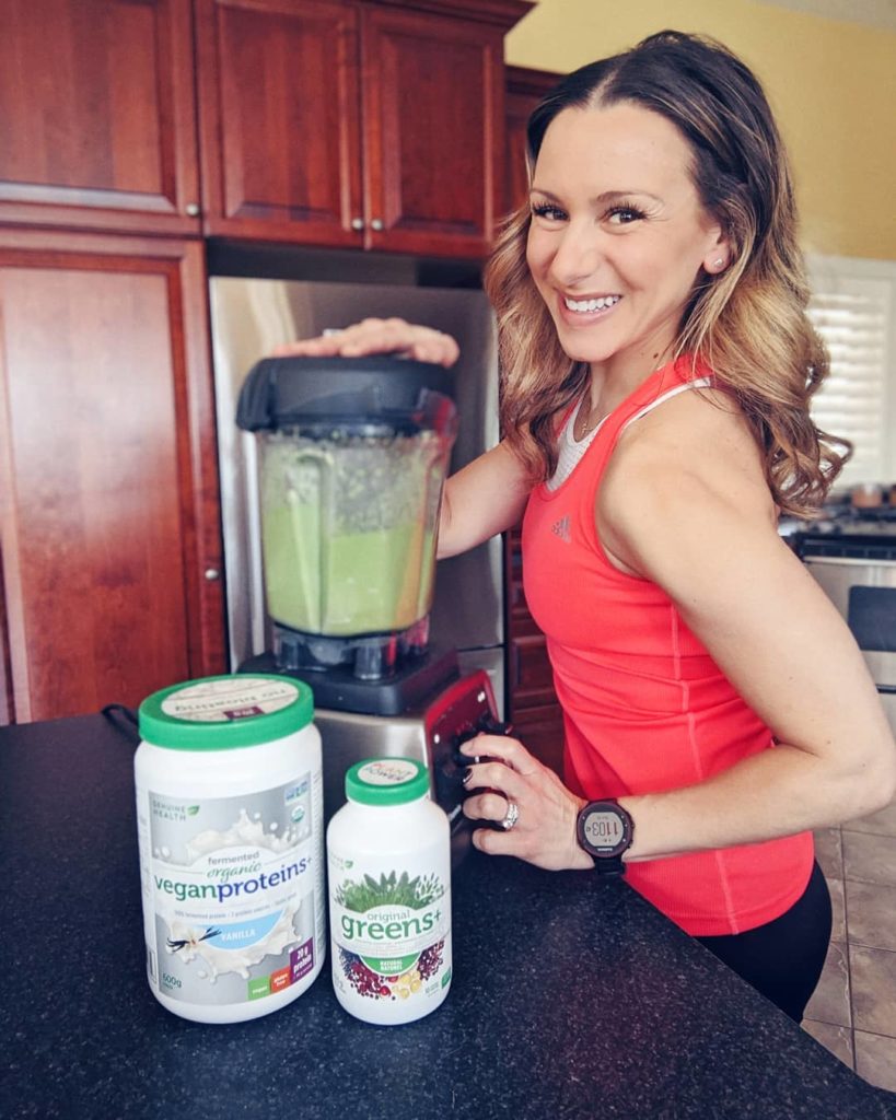 Natalie Pupo smiling while making a protein smoothie