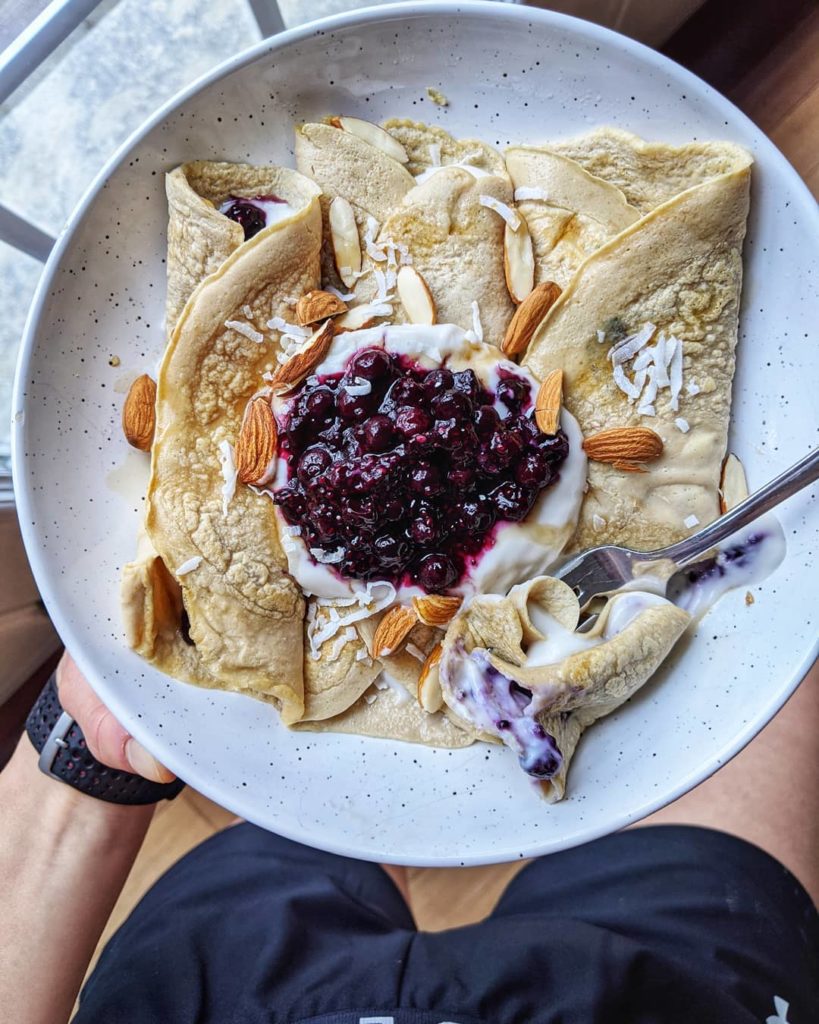 Low carb, high protein crepes topped with almonds and berries